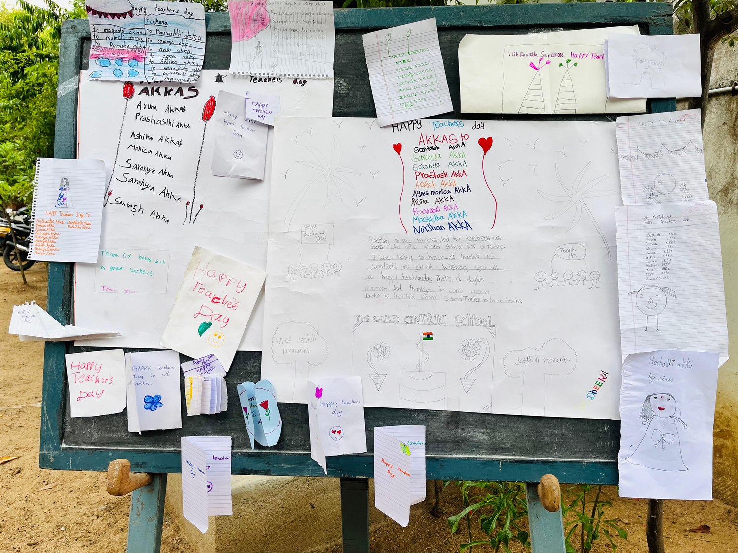 Notes and messages pinned to a board at Mango Woods School