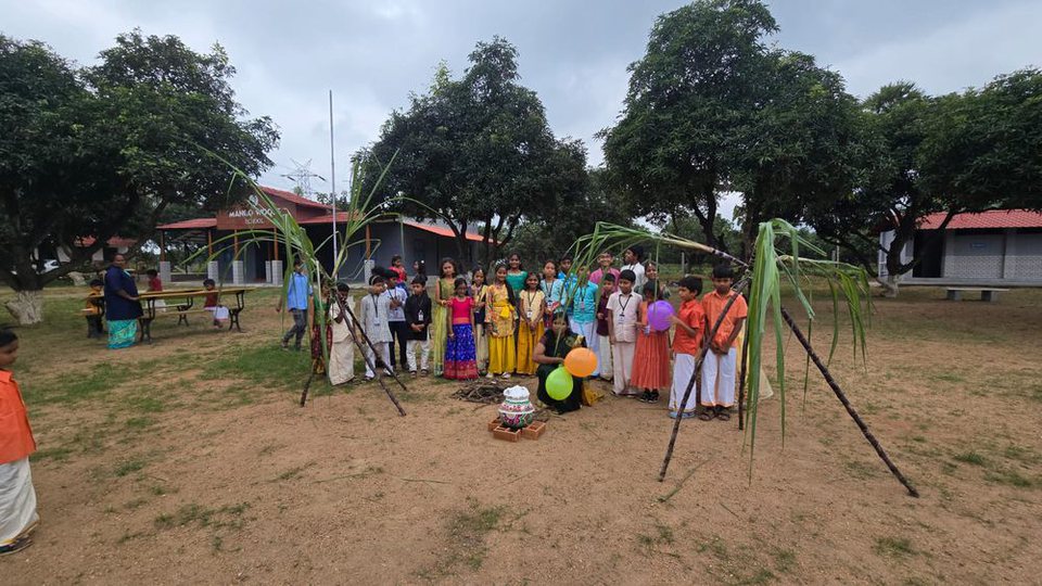 Children celebrating together on the Mango Woods campus